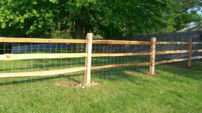 cedar split rail fence with woven wire too keep dog inside yard