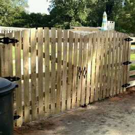picket style gate in post and rail fence